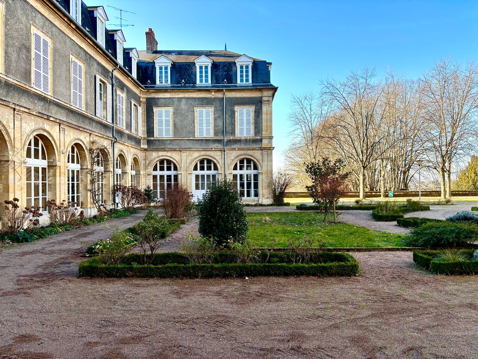 A French country house framed by clipped gardens