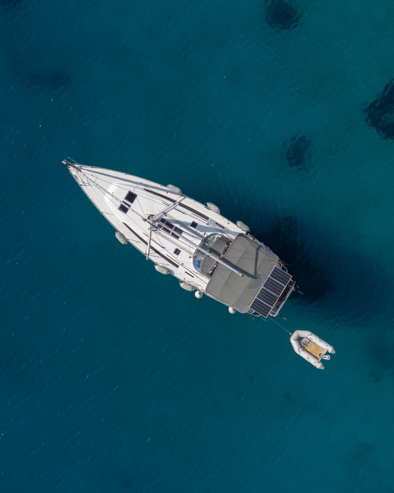 A sailing yacht anchored in clear blue water