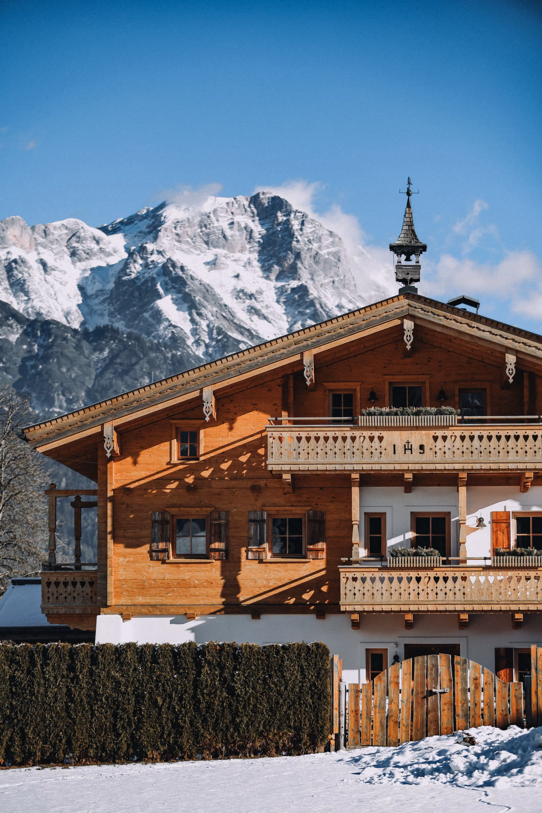 A traditional alpine residence beneath steep mountain peaks