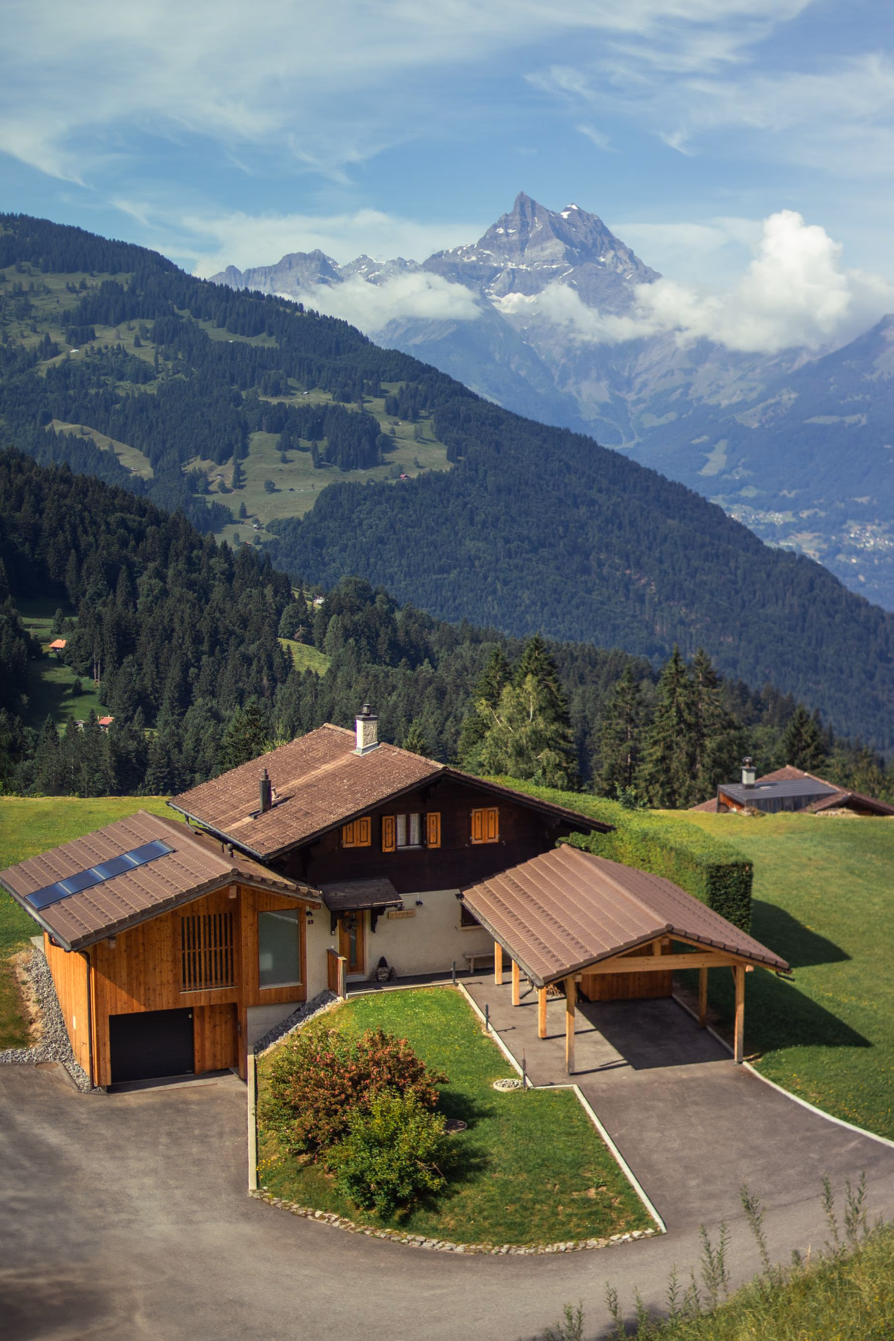 A secluded chalet set above a green alpine valley