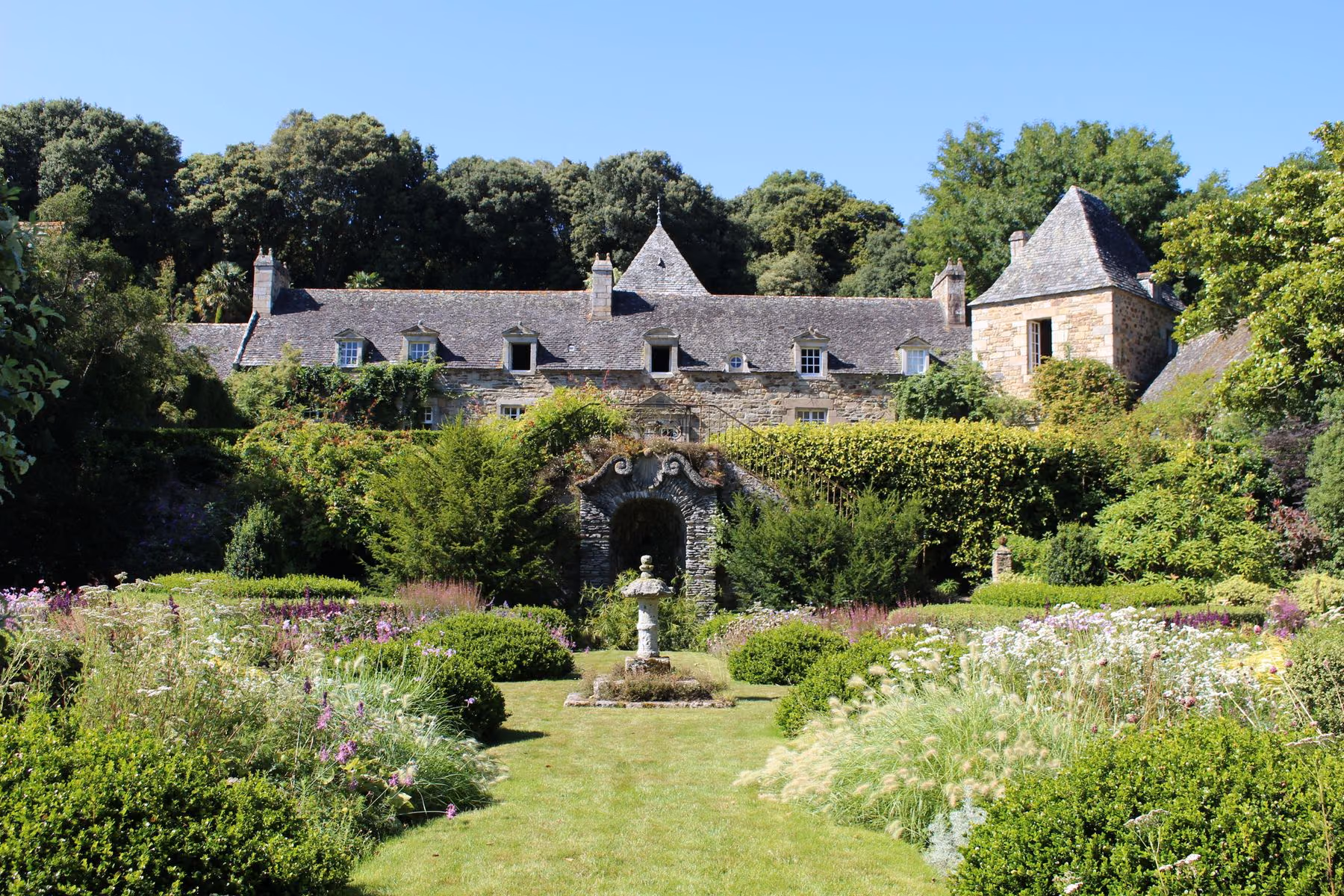 A historic country house surrounded by a formal garden