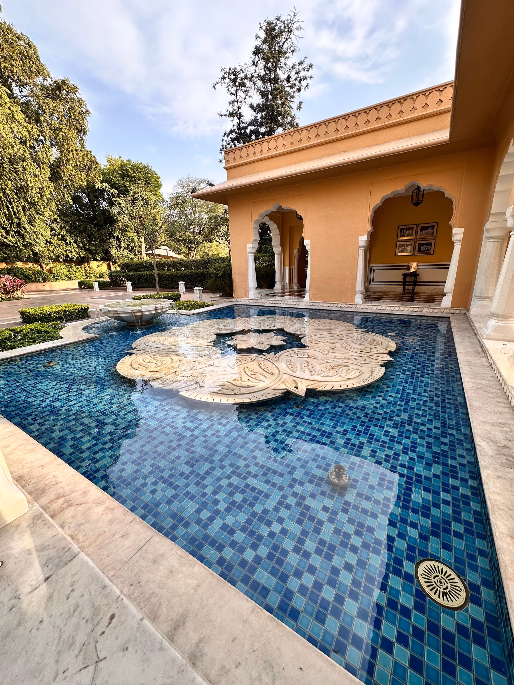 An intimate hotel courtyard arranged around a reflecting pool